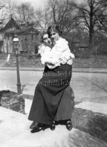 Black-and-white image of two young women hugging