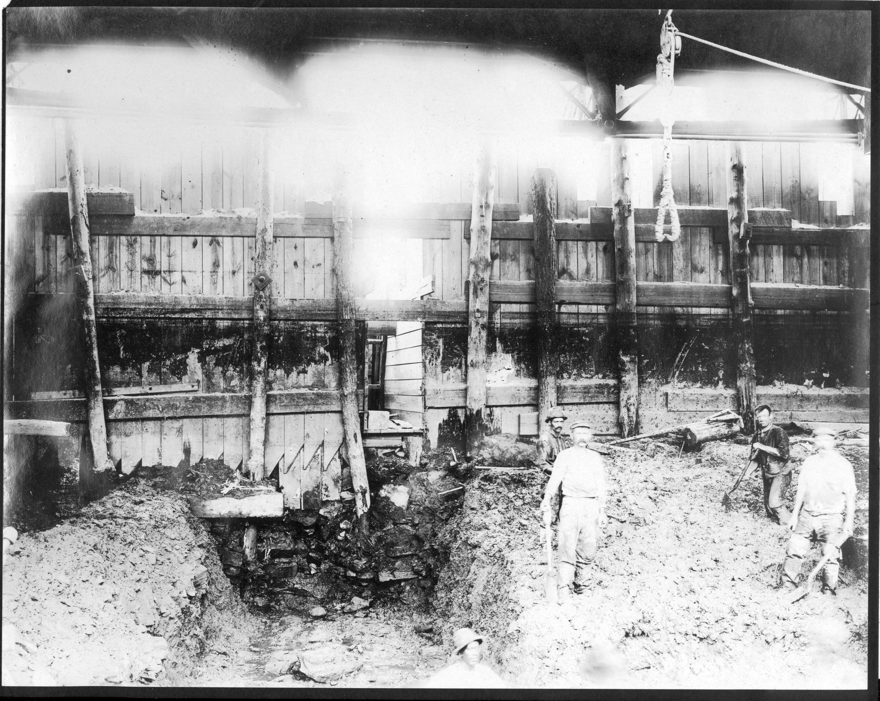Workers in front of a bulkhead or shoring, Aramingo Sewer construction, June 1900