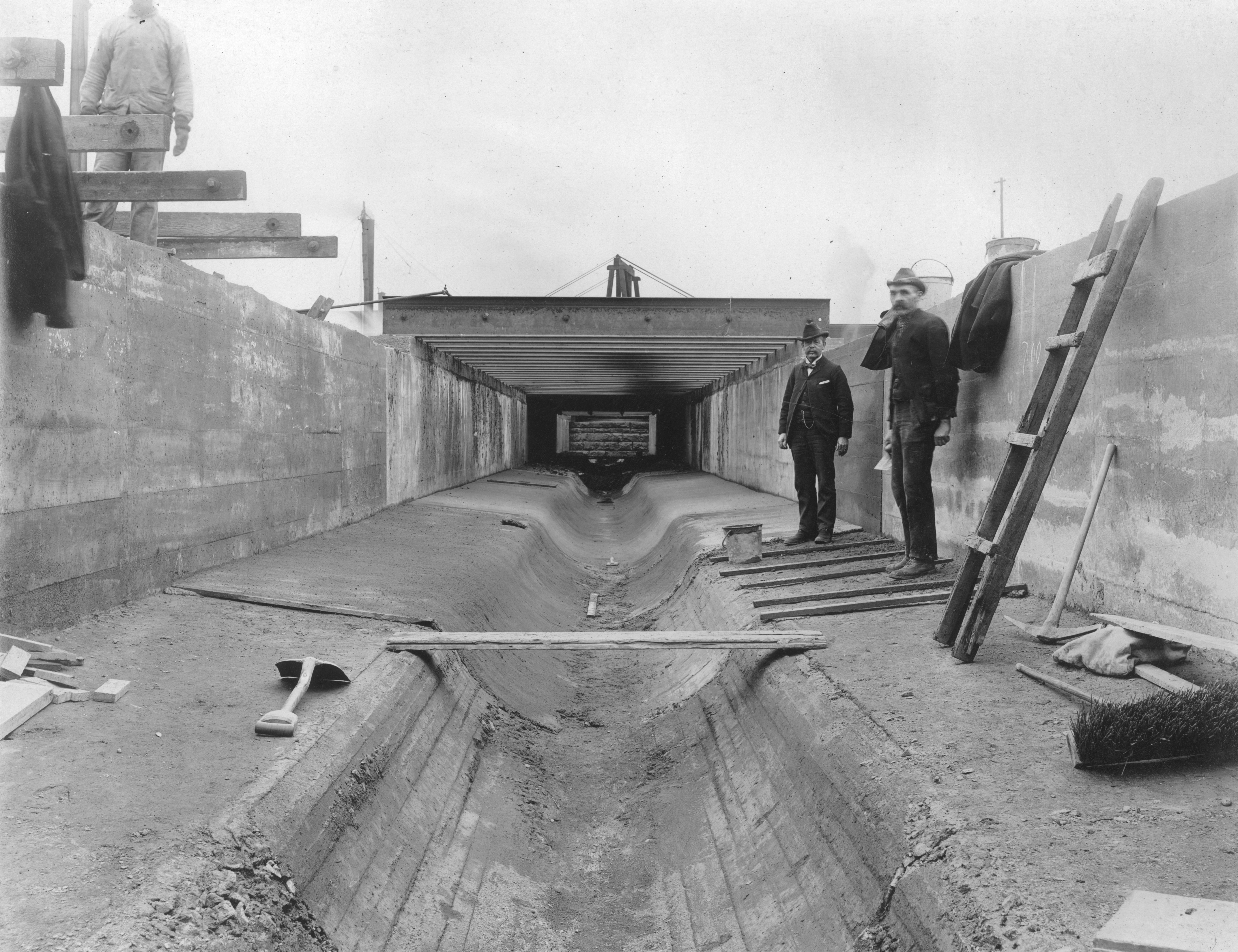 Men posing next to a ladder, near Beach St. Bridge, Aramingo Sewer construction, March 15, 1902