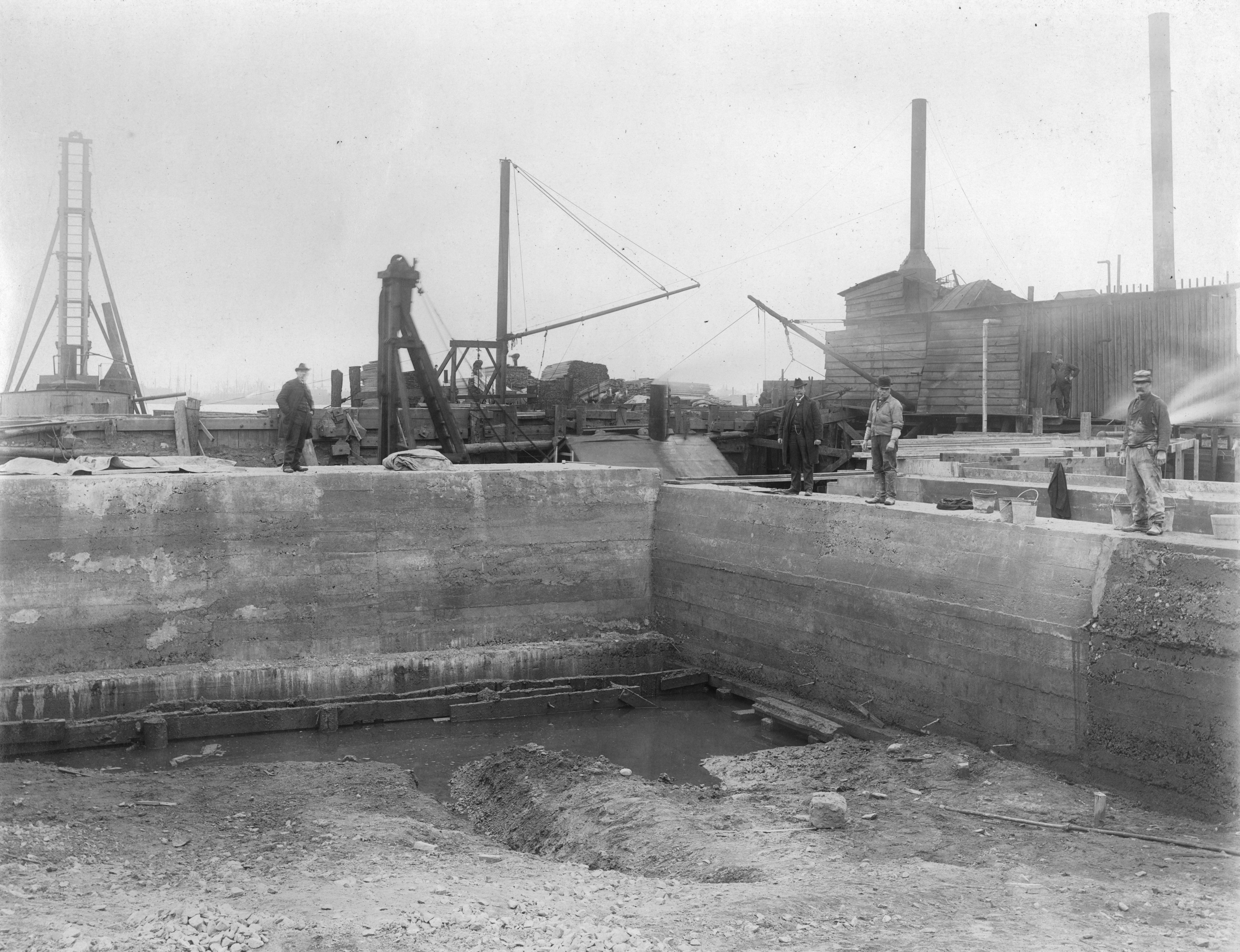 Men watching construction of Aramingo Sewer near Delaware River, 1902