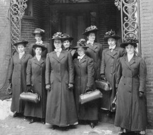 Nine visiting nurses ready for work, ca. 1909