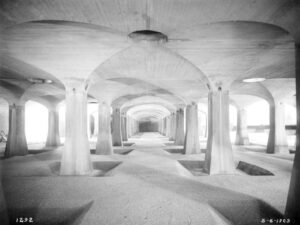 Black-and-white photograph showing the completed Upper Roxborough Filter system. Vaulted concrete ceiling with beds of filter sand.
