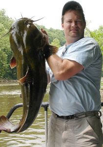 PWD's Lance Butler holds a flathead catfish caught in the Schuylkill River