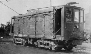 Black-and-white image of a rail car with its door open