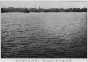 Black-and-white image of a body of water with trees and shoreline in the far distance