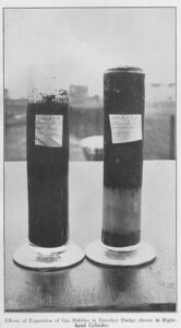 Black-and-white image of two cylinders on a white surface